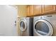 Laundry room featuring a side by side washer and dryer, and built-in cabinets at 2585 E Morgan Dr, Gilbert, AZ 85295