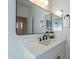 Modern bathroom with a white vanity, black hardware, and framed mirrors at 25925 N 53Rd Dr, Phoenix, AZ 85083