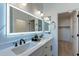 Modern bathroom featuring a double vanity, large mirror, and stylish fixtures creating a luxurious space at 25925 N 53Rd Dr, Phoenix, AZ 85083
