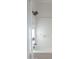 Bright bathroom featuring a white tub, tile surround, and sleek black shower head with modern fixtures at 25925 N 53Rd Dr, Phoenix, AZ 85083