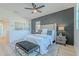 Stylish bedroom showcasing a plush bed, accent wall, ceiling fan, and elegant decor for a comfortable space at 25925 N 53Rd Dr, Phoenix, AZ 85083