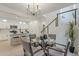 Bright dining area with a glass table, modern chandelier, and view of the kitchen island at 25925 N 53Rd Dr, Phoenix, AZ 85083