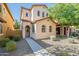 Attractive two-story home with arched windows, low-maintenance landscaping, and a welcoming walkway at 25925 N 53Rd Dr, Phoenix, AZ 85083