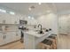 Modern kitchen with white cabinets, stainless steel appliances, and a functional island with bar stools at 25925 N 53Rd Dr, Phoenix, AZ 85083