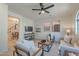 Cozy living room featuring modern furnishings, a ceiling fan, and natural light at 25925 N 53Rd Dr, Phoenix, AZ 85083