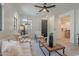 Comfortable living room with modern decor, arched windows, and a view of the kitchen at 25925 N 53Rd Dr, Phoenix, AZ 85083