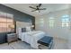 Relaxing main bedroom with a tufted headboard, stylish bench, and bright windows at 25925 N 53Rd Dr, Phoenix, AZ 85083
