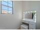 Chic vanity area with lighted mirror, storage drawers, and a comfortable stool, perfect for getting ready at 25925 N 53Rd Dr, Phoenix, AZ 85083