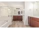 Bathroom with a tub and shower, double vanity, and wood-style tile flooring at 28967 N 124Th Ave, Peoria, AZ 85383
