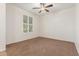 Bright bedroom features a ceiling fan, neutral carpet, and plantation shutters at 28967 N 124Th Ave, Peoria, AZ 85383