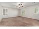 Bedroom with carpet, two windows, and ceiling fan at 28967 N 124Th Ave, Peoria, AZ 85383