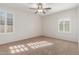 Bedroom featuring neutral walls, carpet, and windows with shutters at 28967 N 124Th Ave, Peoria, AZ 85383