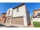 View of a two-story stucco home featuring a brown tile roof and two-car garage at 28967 N 124Th Ave, Peoria, AZ 85383