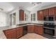 Kitchen featuring wood cabinets, stainless appliances and marble countertops at 28967 N 124Th Ave, Peoria, AZ 85383