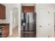 Stainless steel Samsung refrigerator with water dispenser in a well-lit kitchen with tile floors at 28967 N 124Th Ave, Peoria, AZ 85383