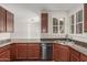 Kitchen featuring granite countertops, stainless dishwasher, wood cabinets and a sink at 28967 N 124Th Ave, Peoria, AZ 85383