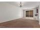 Carpeted living room with sliding glass doors leading to a covered patio at 28967 N 124Th Ave, Peoria, AZ 85383