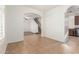 Neutral living room with stairway, arched doorways, and white walls at 28967 N 124Th Ave, Peoria, AZ 85383