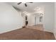 Neutral living room with stairway, arched doorways, and white walls at 28967 N 124Th Ave, Peoria, AZ 85383