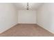 Spacious living room with neutral walls, carpeted floors, and an elegant chandelier at 28967 N 124Th Ave, Peoria, AZ 85383