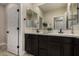 Well-lit bathroom features double sinks, dark cabinets, modern fixtures, and great mirrors at 296 N Jesse St, Chandler, AZ 85225