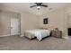 Cozy bedroom features neutral walls, plush carpet, comfortable decor and a view of the ensuite bathroom at 296 N Jesse St, Chandler, AZ 85225