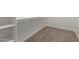 Walk-in closet with carpet, white walls and shelving provides ample storage at 296 N Jesse St, Chandler, AZ 85225