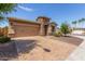 Inviting single-story home with a stone-accented entrance, two-car garage, and a well-maintained paver driveway at 296 N Jesse St, Chandler, AZ 85225