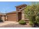 Charming single-story home showcasing a stone accent, two-car garage, and drought-tolerant landscaping at 296 N Jesse St, Chandler, AZ 85225