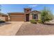 Charming single-story home featuring a stone facade, two-car garage, and desert landscaping for low maintenance at 296 N Jesse St, Chandler, AZ 85225