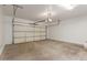 Spacious two car garage with white walls and concrete floors is ready for your cars and storage needs at 296 N Jesse St, Chandler, AZ 85225