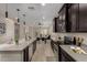 Modern kitchen featuring dark cabinets, stainless steel appliances, and a large island with pendant lighting at 296 N Jesse St, Chandler, AZ 85225