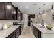 Modern kitchen with dark cabinetry, stainless steel appliances, and a large island with counter seating at 296 N Jesse St, Chandler, AZ 85225