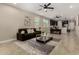 Bright living room featuring neutral walls, modern ceiling fan, and an open floor plan leading to the kitchen and dining area at 296 N Jesse St, Chandler, AZ 85225
