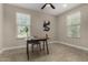 Bright office features neutral walls, stylish desk, tiled floors, and bright natural light from two large windows at 296 N Jesse St, Chandler, AZ 85225
