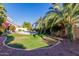 Relaxing backyard featuring a spacious lawn, vibrant foliage, and ample space for outdoor activities at 2977 E County Down Dr, Chandler, AZ 85249