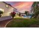 Well-manicured backyard features lush lawn and comfortable seating near a sparkling pool, ideal for outdoor enjoyment at 2977 E County Down Dr, Chandler, AZ 85249