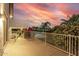 Upper balcony featuring sunset views of the community, desert landscaping, and a view of the pool at 2977 E County Down Dr, Chandler, AZ 85249
