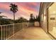 Spacious balcony featuring sunset views with desert landscaping, a grill, and an entrance to the home at 2977 E County Down Dr, Chandler, AZ 85249