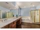 Bright bathroom offers double sinks, large mirror, and a separate shower and bathtub at 2977 E County Down Dr, Chandler, AZ 85249