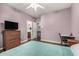 Bedroom with wood floors, desk, and ensuite bathroom is comfortable and inviting at 2977 E County Down Dr, Chandler, AZ 85249