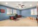 Bedroom featuring large windows, an executive desk, and a ceiling fan at 2977 E County Down Dr, Chandler, AZ 85249