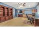 Bedroom featuring an executive desk, built-in storage, TV, and a ceiling fan at 2977 E County Down Dr, Chandler, AZ 85249