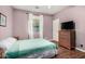Cozy bedroom with light purple walls, window, and a chest of drawers for storage at 2977 E County Down Dr, Chandler, AZ 85249