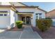 Inviting entryway with gray trim, lush landscaping, and well-maintained walkway at 2977 E County Down Dr, Chandler, AZ 85249