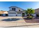 Beautiful two-story home featuring a three-car garage and desert landscaping at 2977 E County Down Dr, Chandler, AZ 85249