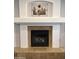 Close-up of a cozy fireplace with decorative tile surround and white mantel at 2977 E County Down Dr, Chandler, AZ 85249