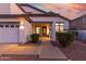 Charming single-story home featuring manicured landscaping and a welcoming front entrance with a security system at 2977 E County Down Dr, Chandler, AZ 85249