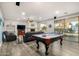 Bright game room featuring a pool table, fireplace, and sliding glass doors at 2977 E County Down Dr, Chandler, AZ 85249