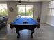 A large game room is staged with a pool table and open concept living spaces at 2977 E County Down Dr, Chandler, AZ 85249
